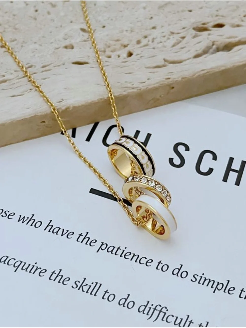 Coach Gold Necklace with White and Black Enamel Ring Pendants